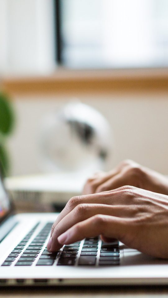 person typing on laptop